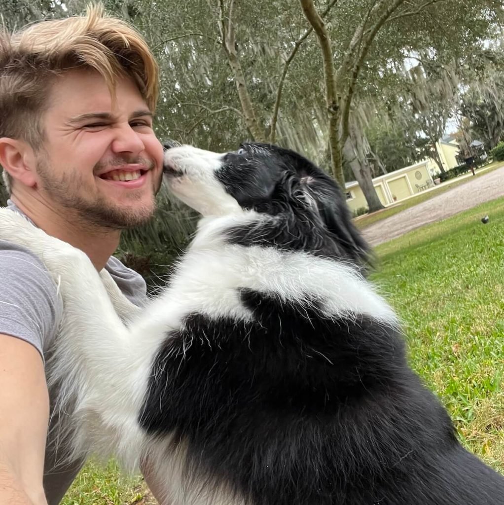 evan and a border collie at the park