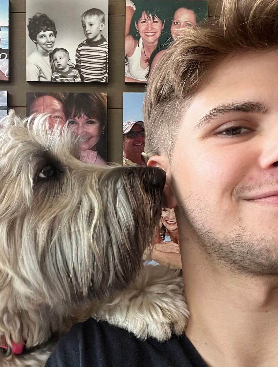 evan with a dog licking his ear